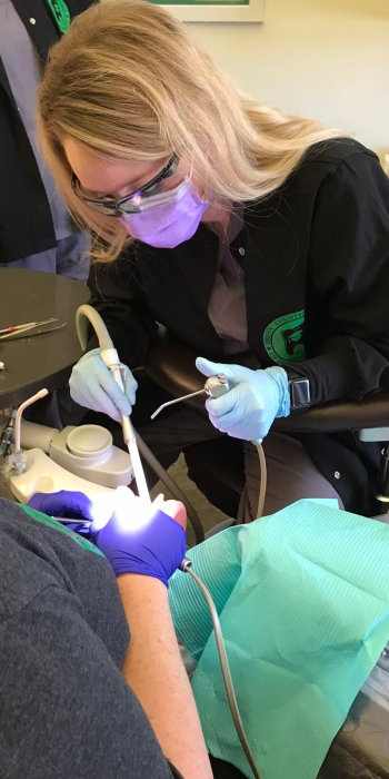 Dental assisting student practing dental treatment