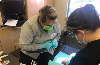 Dental assisting student learning from instructor