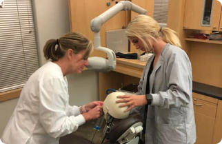 Dental assisting student practicing treatment on dental model