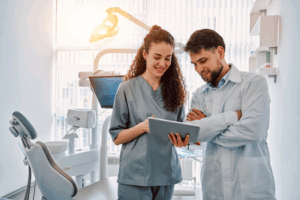 a pair of dental assistants smiling