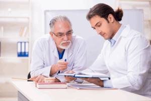a dental assisting student speaking with his instructor