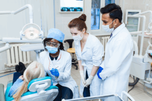 a dental assisting instructor teaching two students