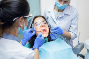 a group of dental assistants helping a patient