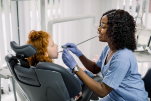 a dental assistant working with a child 
