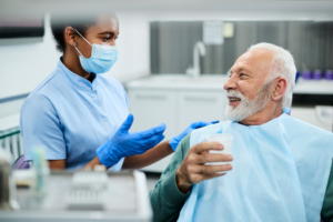 a dental assistant speaking with a patient
